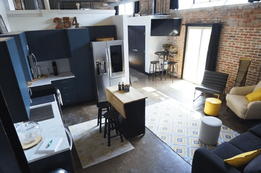 A modern open-concept apartment with a kitchen, dining area, and living room in McLennan County, Texas.