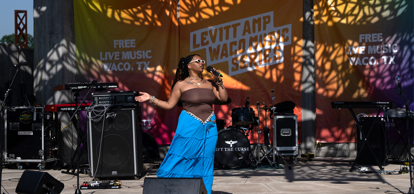 A female singer performs on stage at the Levitt AMP Waco Music Series in McLennan County, Texas.