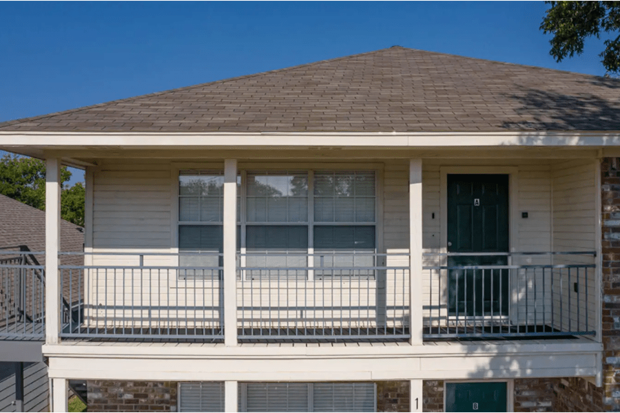 A second-story apartment balcony with a dark door labeled A in McLennan County, Texas.