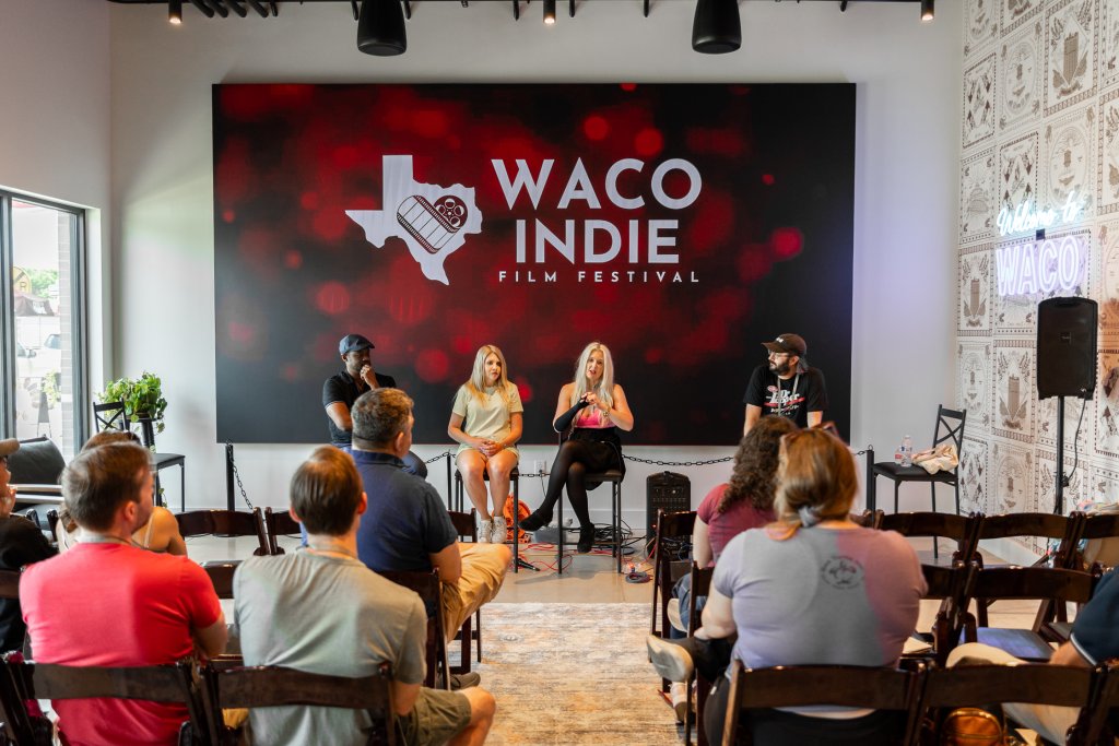 A panel discussion takes place on stage at the Waco Indie Film Festival in McLennan County, Texas.
