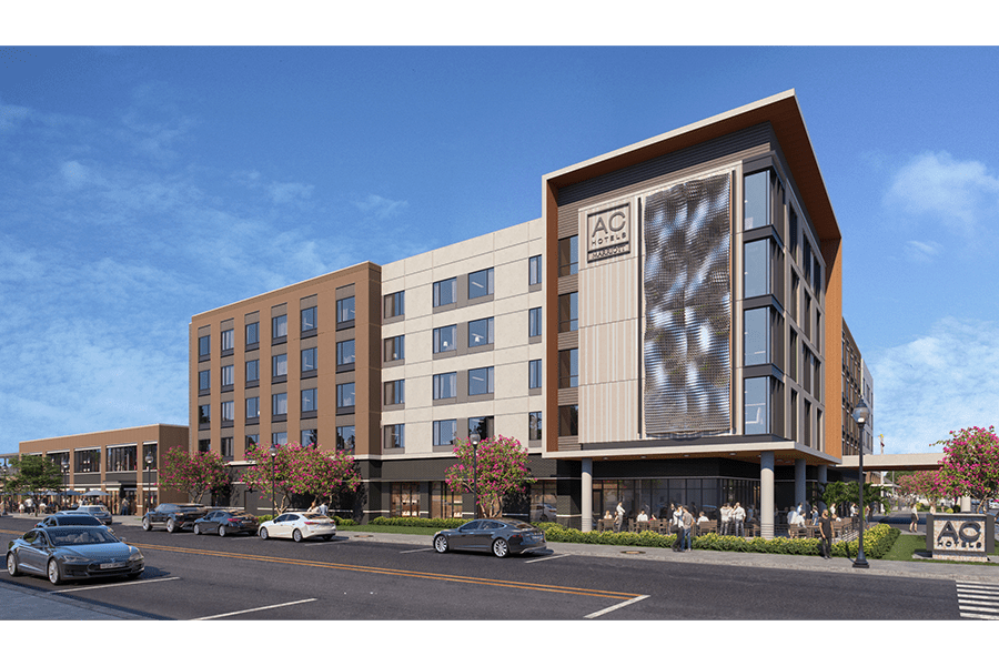 A modern AC Hotel building with cars parked on the street in front in McLennan County, Texas.