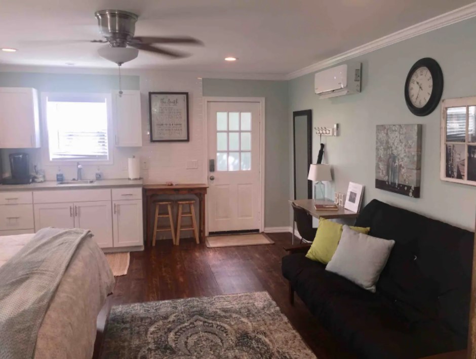 A cozy studio apartment with a kitchenette, a futon, and a bed in McLennan County, Texas.