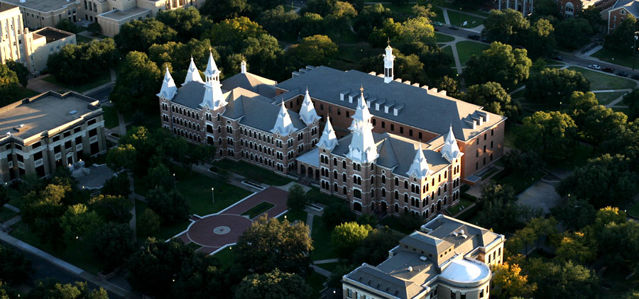 An aerial view of a large brick university building with multiple towers in McLennan County, Texas.