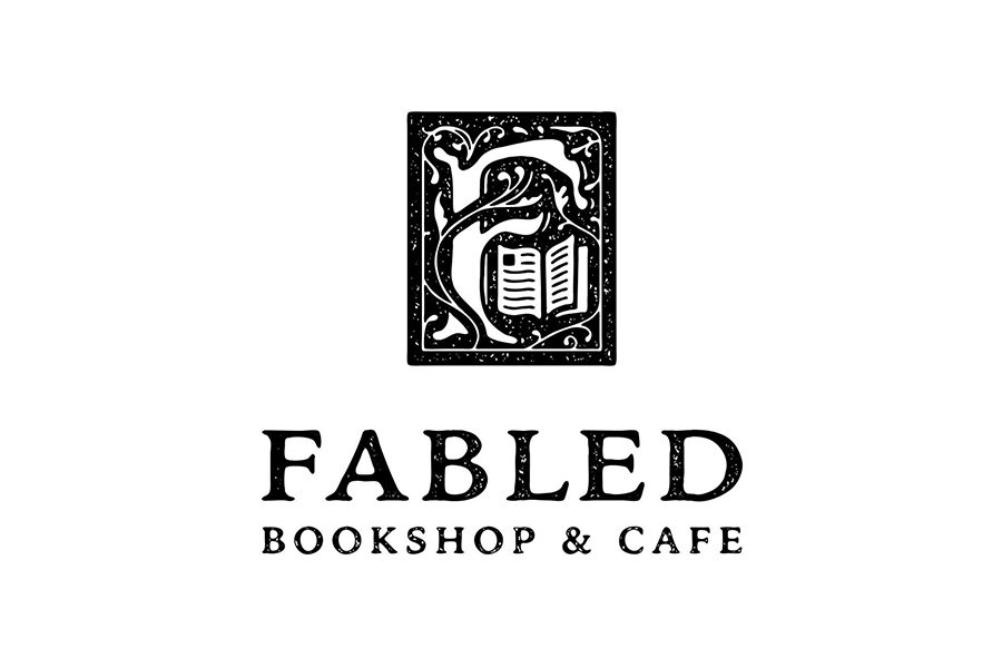 A logo for Fabled Bookshop and Cafe featuring a stylized letter F with a book in McLennan County, Texas.