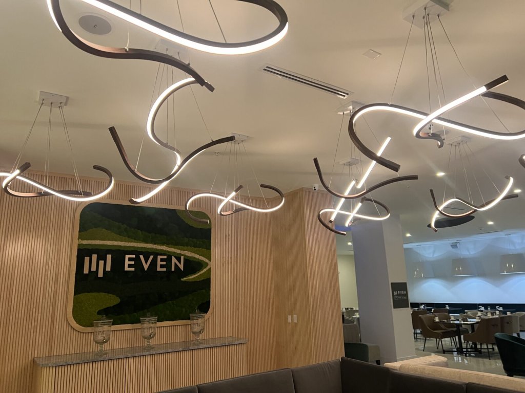 Modern lobby with unique curved LED pendant lights and a moss wall logo in McLennan County, Texas.