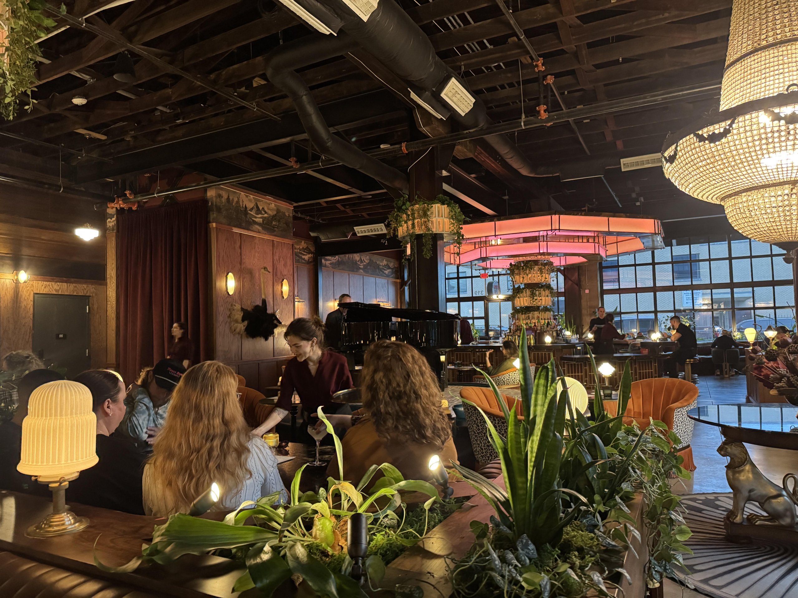 A server waits on a group of people in a dimly lit, upscale restaurant in McLennan County, Texas.
