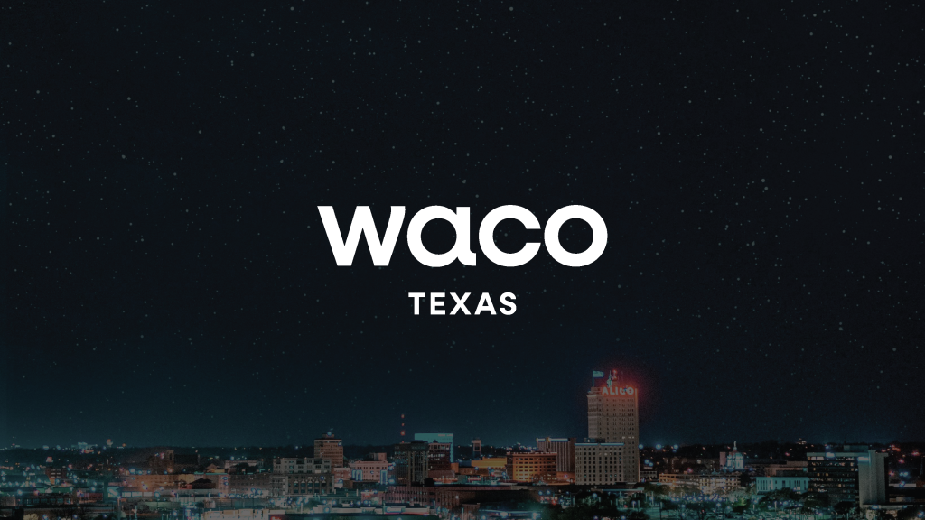 The city skyline of Waco, Texas, at night under a starry sky in McLennan County, Texas.