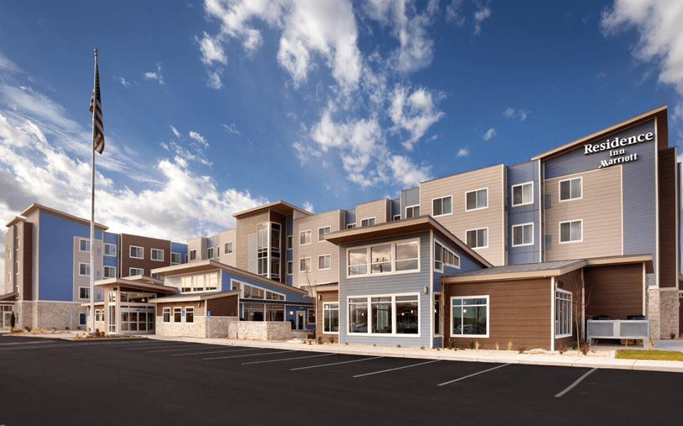 A modern Residence Inn by Marriott hotel building under a bright blue sky in McLennan County, Texas.