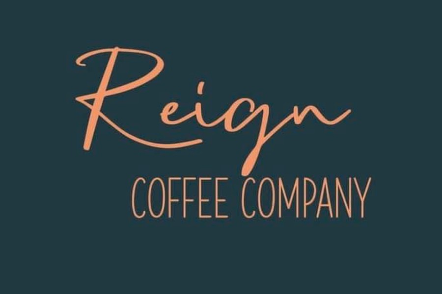 The logo for Reign Coffee Company in peach script and sans-serif text on dark background in McLennan County, Texas.