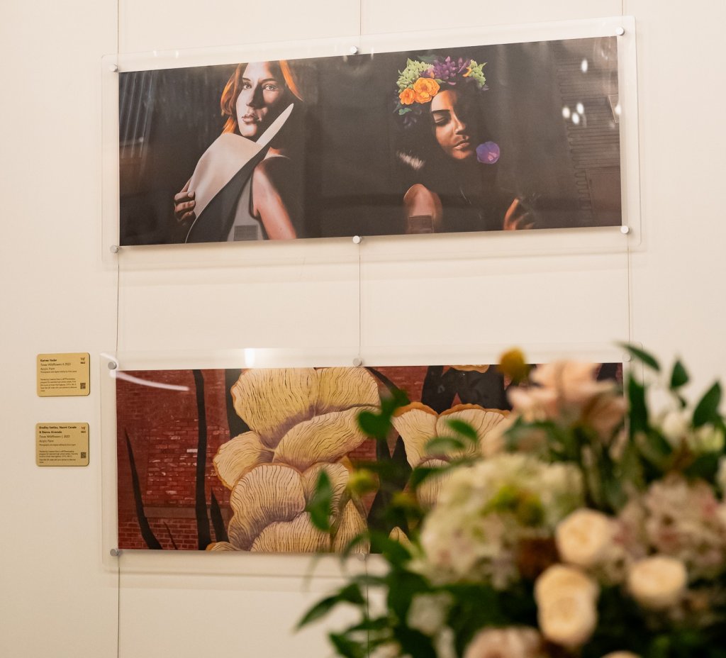 Two framed art prints hanging on a white wall above a flower arrangement in McLennan County, Texas.