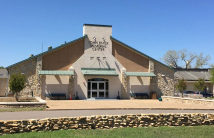 The exterior of the John Knox Memorial Center building under a clear blue sky in McLennan County, Texas.