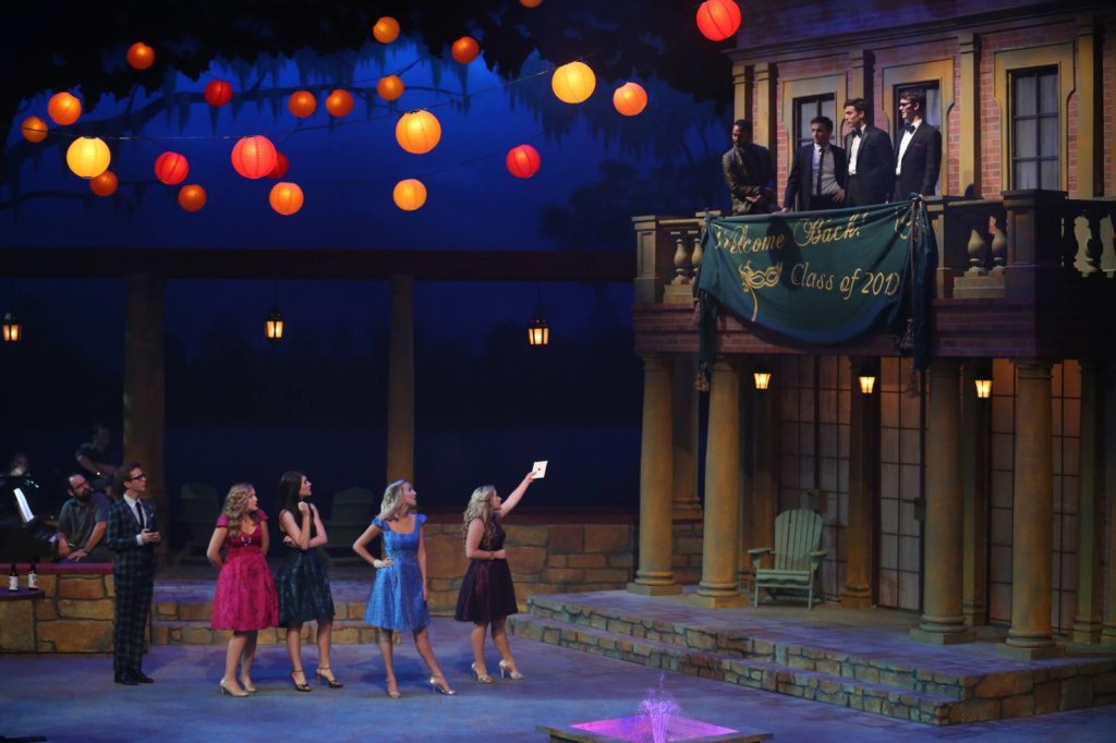 A theatrical performance featuring actors on a stage decorated with hanging paper lanterns in McLennan County, Texas.