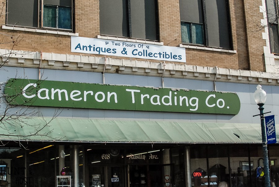The storefront of Cameron Trading Co. featuring an antiques and collectibles sign in McLennan County, Texas.