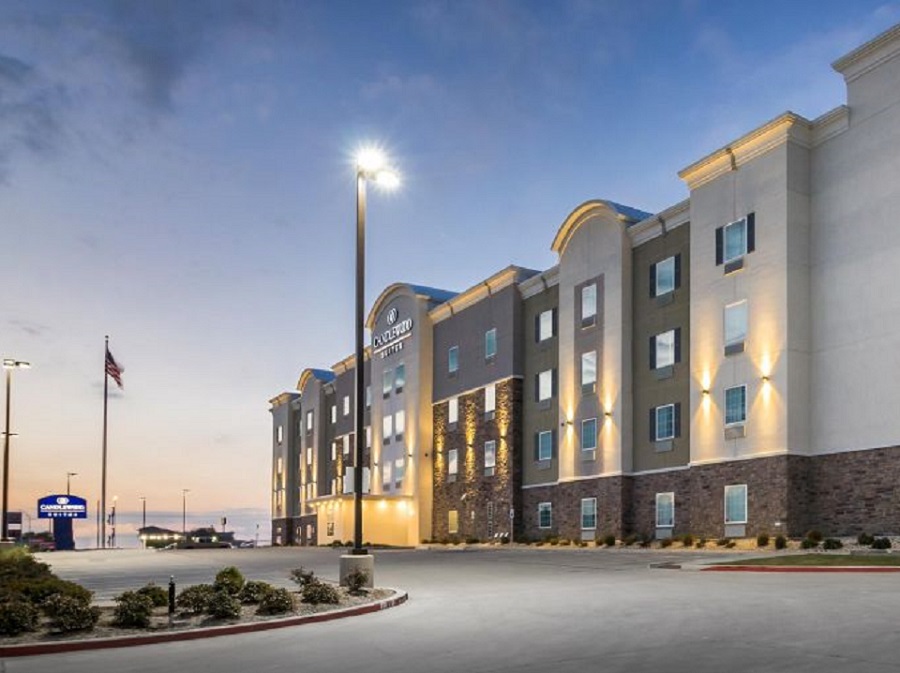 A Candlewood Suites hotel building exterior at dusk with parking lot lights on in McLennan County, Texas.