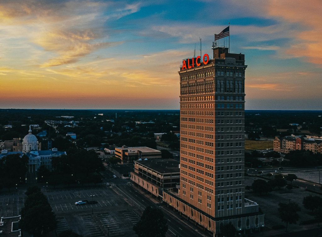 The Alico building stands tall in a city skyline during a vibrant sunset in McLennan County, Texas.