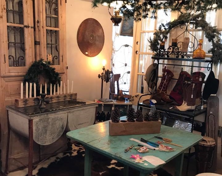 A rustic shop interior featuring a turquoise table, vintage decor, and cowboy boots in McLennan County, Texas.