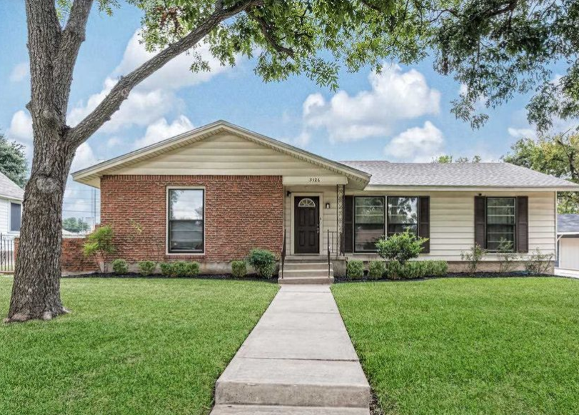 A single-story brick and siding house with a front lawn and walkway in McLennan County, Texas.