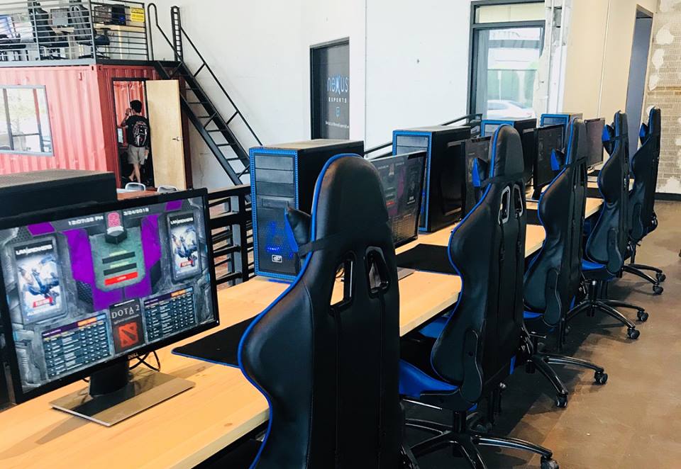 A row of gaming computers and chairs in a modern office space in McLennan County, Texas.