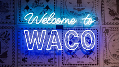 A bright neon sign reading Welcome to WACO against a patterned background in McLennan County, Texas.