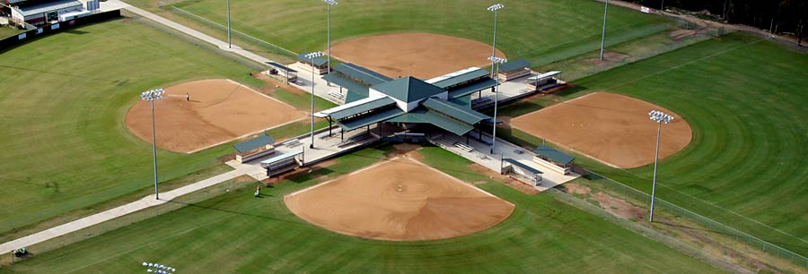 An aerial view of a four-field baseball complex with a central hub in McLennan County, Texas.