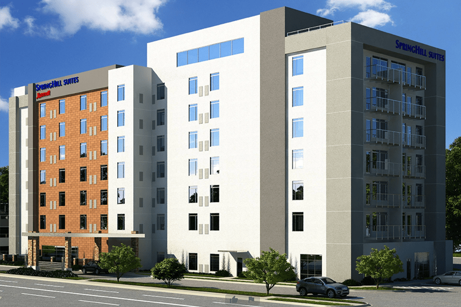 A modern multi-story SpringHill Suites hotel building with a brick and white facade in McLennan County, Texas.