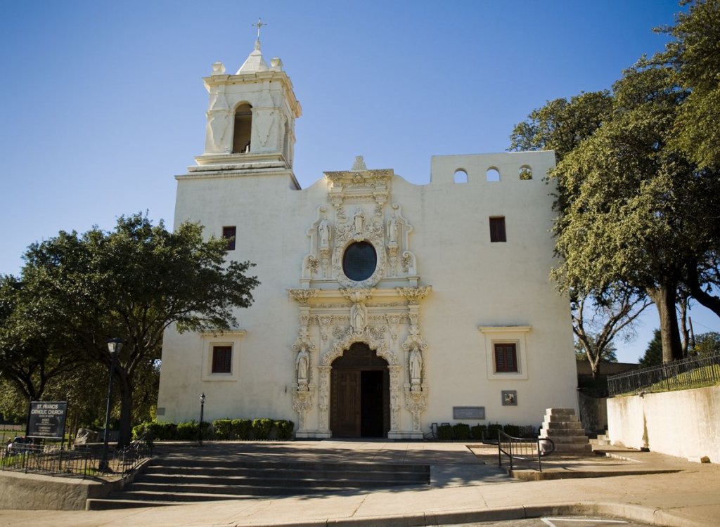 The historic white stone facade of Mission San Francisco de la Espada in McLennan County, Texas.
