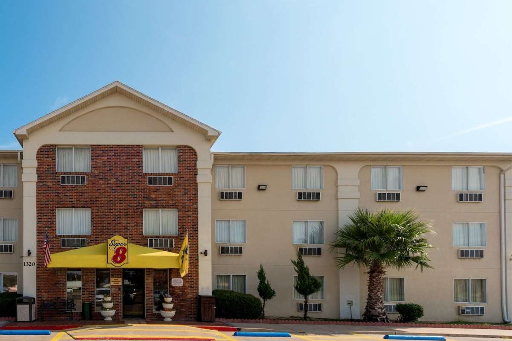 A Super 8 motel building with a brick facade and a yellow entrance awning in McLennan County, Texas.