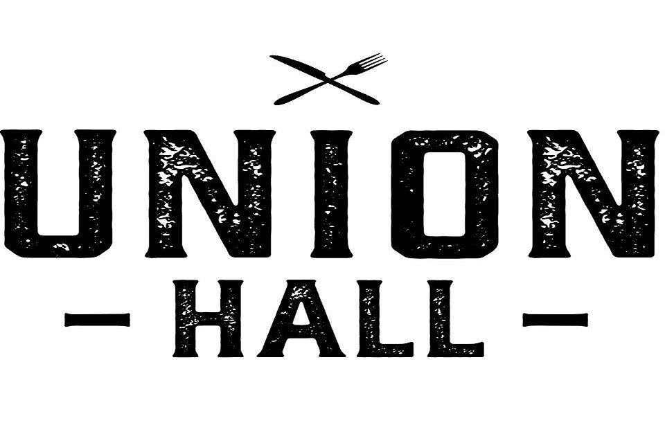 A black and white logo for Union Hall featuring crossed cutlery in McLennan County, Texas.