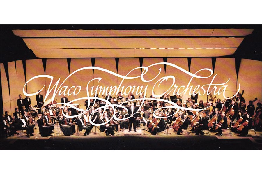 The Waco Symphony Orchestra performing on stage with a conductor in McLennan County, Texas.