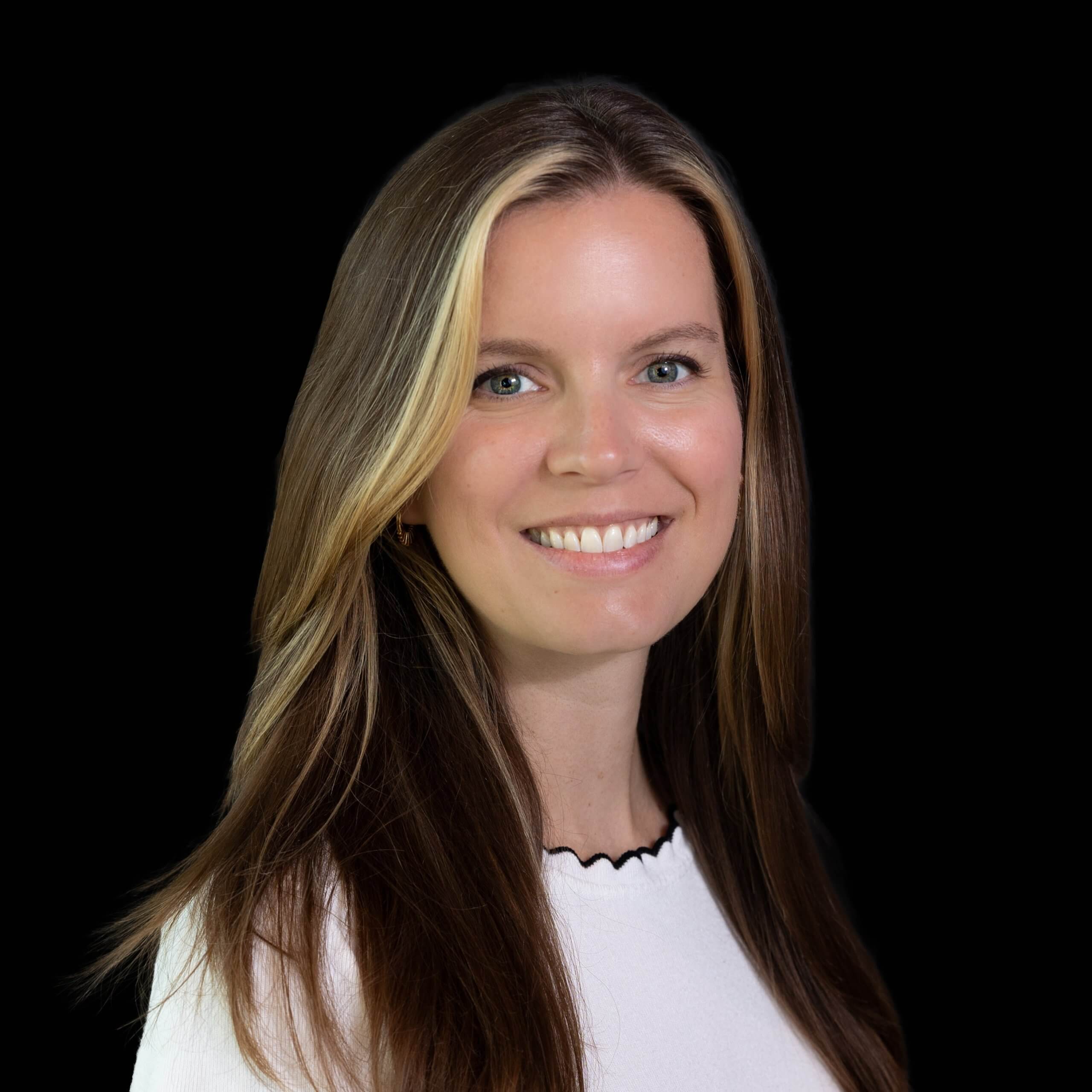 A smiling woman with long brown hair and blonde highlights against a black background in McLennan County, Texas.