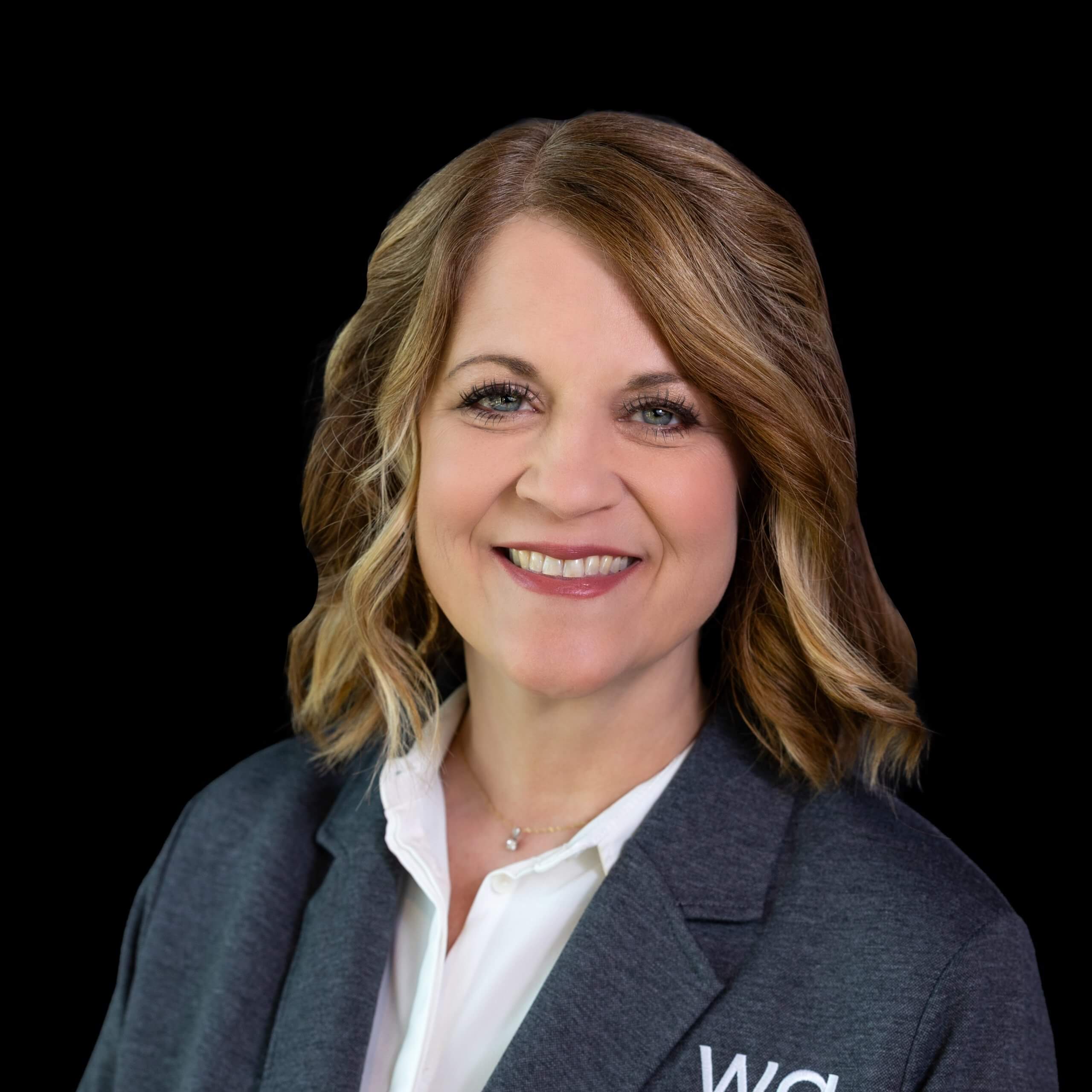 A professional headshot of a smiling woman with shoulder-length brown hair in McLennan County, Texas.