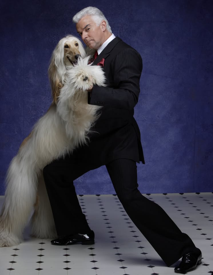 A man in a tuxedo dancing with a long-haired Afghan hound in McLennan County, Texas.