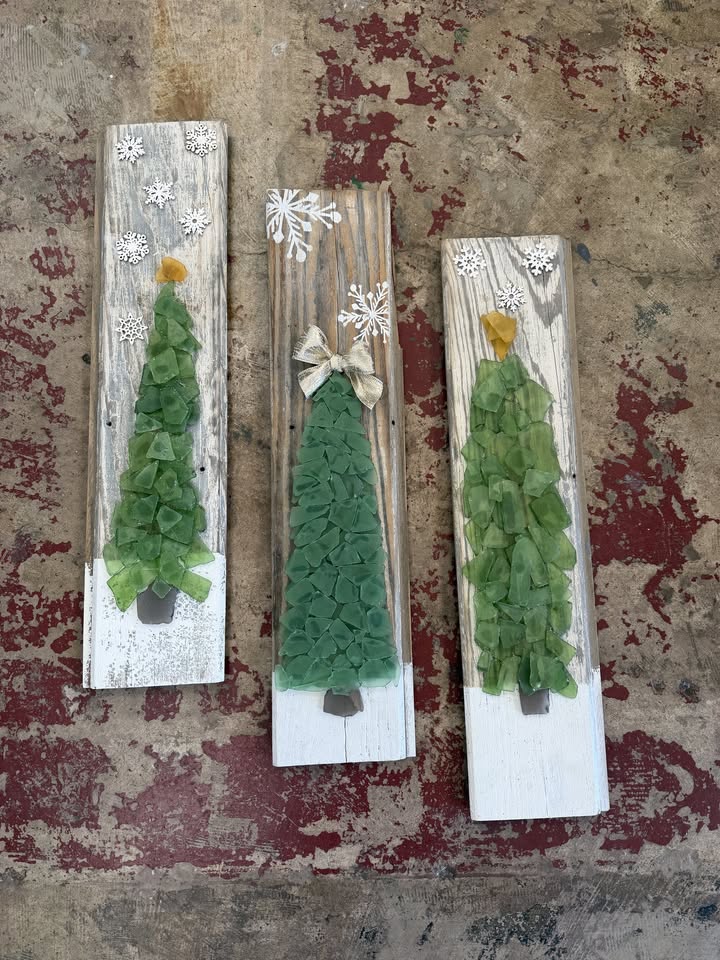 Three rustic wooden planks decorated with sea glass Christmas trees and snowflake accents in McLennan County, Texas.