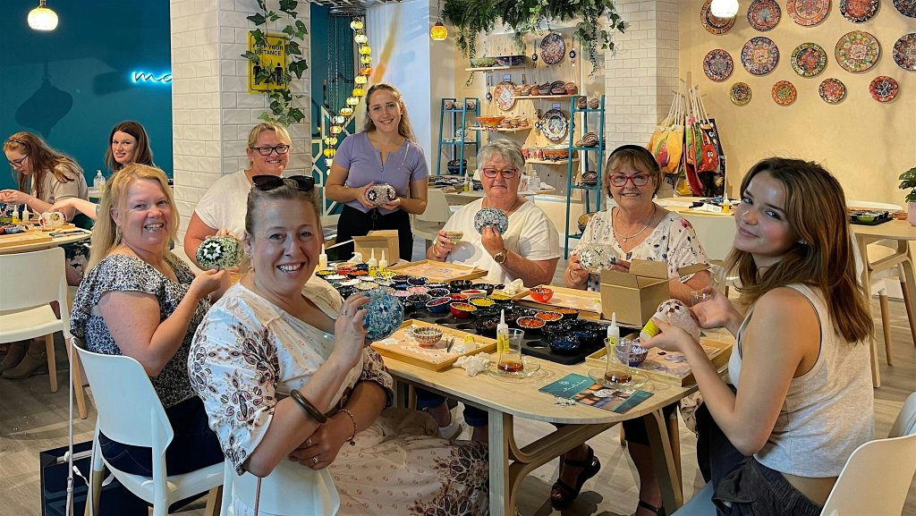 A group of women participating in a mosaic art workshop at a table in McLennan County, Texas.