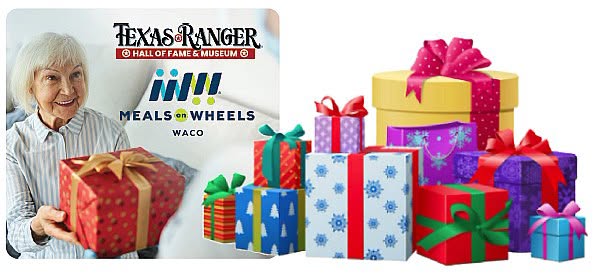 An elderly woman holding a gift next to a pile of wrapped presents in McLennan County, Texas.
