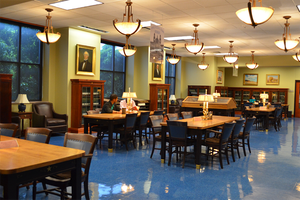 A quiet library interior with wooden tables, chairs, and hanging pendant lights in McLennan County, Texas.